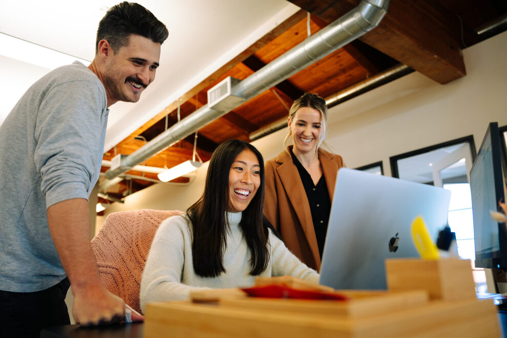Power Digital team members collaborating at a workstation in their office
